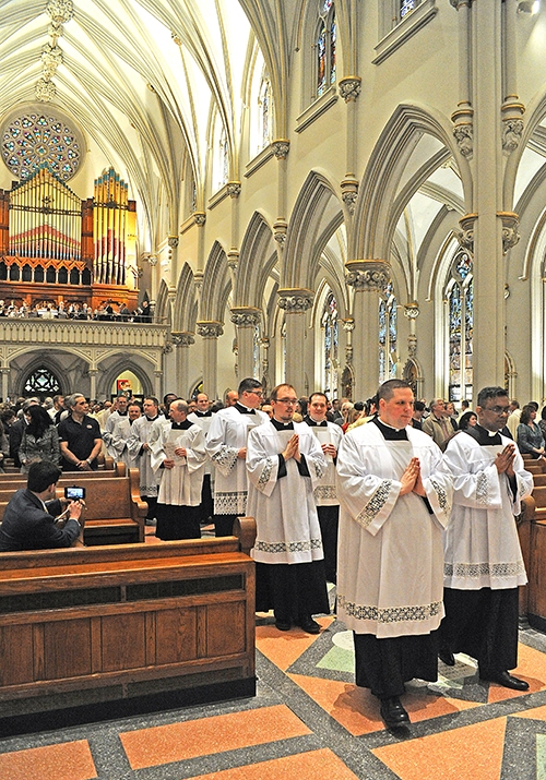 Diocesan priests process into St. Joseph Cathedral to begin the annual Chrism Mass. (Dan Cappellazzo/Staff Photographer)